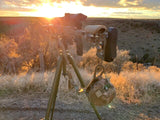 Sniper Rifle sitting on Hog Saddle Tripod under fall sunset